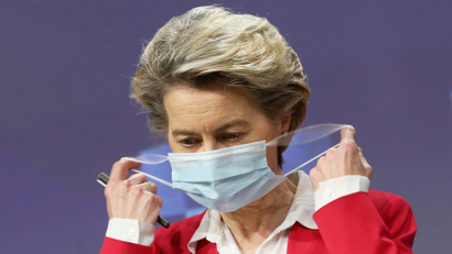 European Commission president Ursula Von Der Leyen removes her protective face mask