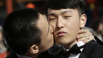Zhang Yi (L) kisses Hai Bei as the same-sex couple pose for their wedding photographs at Qianmen street on Valentine's Day in Beijing February 14, 2009. For some in Beijing's gay and lesbian community, Valentine's Day is not just a day to celebrate loving relationships but also an ideal time to campaign for same-sex marriages and the acceptance of homosexuality in China. REUTERS/Jason Lee