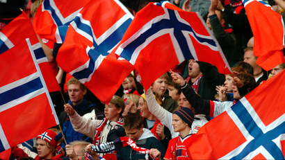 Norwegian soccer fans celebrate in the stands of a World Cup qualifier match.