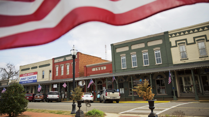 american flag over small town