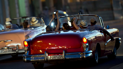 Tourists ride in vintage American convertible cars, on the Malecon in Havana, Cuba, Sunday, Dec. 28, 2014. Cuba and the U.S. announced on Dec. 17 that the two countries would resume diplomatic relations for the first time since 1961.