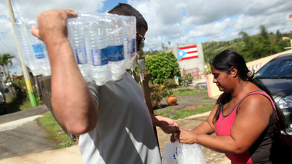 Municipal workers distribute water and ice provided by the U.S. Federal Emergency Management Agency (FEMA), after Hurricane Maria hit the island in September 2017