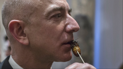 Jeff Bezos holding a cockroach lollipop close to his mouth..