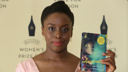Author Chimamanda Ngozi Adichie poses with her novel "Americanah" ahead of the 2014 Bailey's Women's Prize for Fiction in London