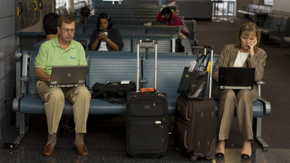 Travelers check email at airport.