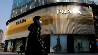 A man walks past a Prada store in Beijing