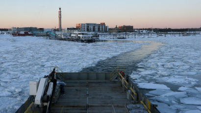 The Warren Jr., a 150 foot offshore supply boat, cuts a path through the ice as it works as an ice breaker for the commuter ferry in the waters off Hingham, Massachusetts March 3, 2015. With its black hull rumbling against a field of broken ice, the Warren Jr. slowly eased away from a dock in the Boston suburb of Hingham on Tuesday, aiming to clear a path for some of the four ferries that carry commuters from here into the city each day. But in a sign of how long Massachusetts has been gripped by freezing temperatures, no other vessels followed, as the tide narrowed the channel behind the ocean-going supply boat pressed into service as an icebreaker. It was the 15th day of canceled ferry service since late January and the outing was meant to speed the fleet's return to service, which could still be days away. REUTERS/Brian Snyder (UNITED STATES - Tags: ENVIRONMENT TRANSPORT)