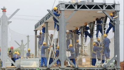 Labourers install the steel frames of a construction site of the three-storey D3 cafeteria built by the Broad Group in Yueyang, Hunan province April 24, 2012. The structure is an example of streamlined construction being pioneered by China's Broad Sustainable Building (BSB). Over the last decade China has seen one of the biggest construction booms in history to house a surging urban population and an expanding industrial sector. But with that construction have come worries about environmental destruction, waste and shoddy buildings. Zhang Yue, Broad Group's founder and chairman argues that his buildings represent just the opposite. Picture taken April 24, 2012. To match story CHINA/INSTANT-BUILDING/ REUTERS/Terril Yue Jones