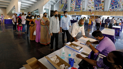 People queue to register their names to get a dose of COVISHIELD, a coronavirus disease (COVID-19) vaccine, in Ahmedabad