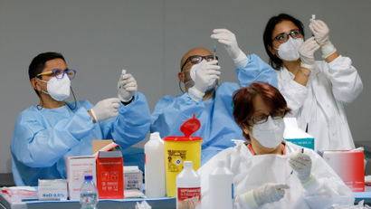 Health workers prepare doses of the Pfizer-BioNTech COVID-19 vaccine at a coronavirus disease (COVID-19) vaccination centre in Naples, Italy.