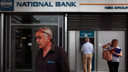 People are seen outside a National Bank branch in Athens