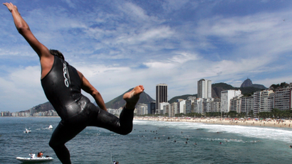 Australian swimmer Ky Hurst dives into ocean above Copacabana beach during Rio quadrathalon.
