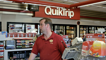 Patrick Field, an employee at the Quick Trip store in Florissant, Mo., waits on customers Thursday, April 13, 2006. The biggest Powerball jackpot in Missouri history, $224.2 million, remains unclaimed after the winning ticket was sold at the Florissant QuikTrip convenience store.