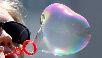 An activist blows a bubble during an event to raise awareness for bladder cancer outside the European Parliament in Brussels