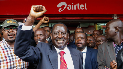 The leader of the opposition coalition the National Super Alliance (NASA) and its presidential candidate Raila Odinga (C) cheers to his supporters after getting his new Airtel sim card at an Airtel shop in Nairobi, Kenya, 06 November 2017. Odinga and other coalition leaders on 06 November switched his mobile phone service provider to Airtel from Safaricom, one of the companies he accuses of being pro-government. NASA has called its supporters to boycott products by companies it accuses of supporting the government after the coalition boycotted the presidential election held on 26 October 2017 in which the President Uhuru Kenyatta was declared the president-elect.