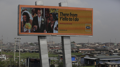 In this photo taken Tuesday, Nov. 17, 2015, an MTN advertisement is seen on a giant electronic board over a slum in Lagos, Nigeria. Nigeria's authorities have levied a US dlrs 5.2 billion fine to Africas largest telecommunications company, MTN, for having 5.2 million active but unregistered SIM cards, which authorities allege are a matter of national security in Nigeria and may have caused deaths. The dlrs 5.2 billion fine is far more than any company has been fined anywhere in the world according to industry expert John Strand of Denmark-based Strand Consult.