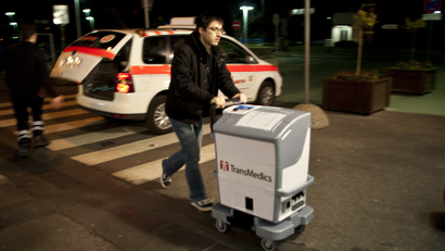 An assistant doctor arrives with a human lung in an 'Organ Care System' for a lung transplantation at the Hannover Medical School March 20, 2012.