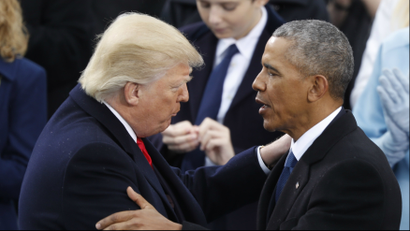Donald Trump and Barack Obama greeting each other.