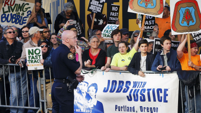 Protesters, many against the so-called fast track trade authority of the Trans-Pacific Partnership (TPP) trade agreement, rally outside the hotel where U.S. President Barack Obama is participating in a Democratic National Committee (DNC) event in Portland, Oregon May 7, 2015.