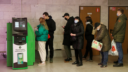 People queue at an ATM in Russia.