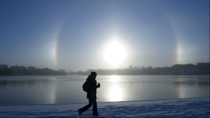 A parhelion (sundog) combined with a halo is seen over Lake Malaren in central Stockholm.