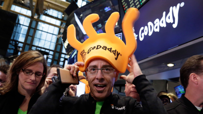 GoDaddy CEO Blake Irving puts on a foam hat on the floor of the New York Stock Exchange as he waits for his company's IPO to begin trading, Wednesday, April 1, 2015. (AP Photo/Richard Drew)