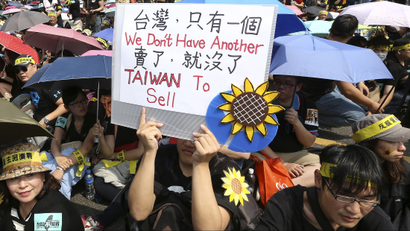 A demonstrator holds placard in front of the Presidential Office in Taipei March 30, 2014. Thousands of demonstrators marched the streets on Sunday to protest against the controversial trade pact with mainland China. REUTERS/Patrick Lin