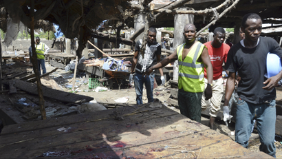 Rescue workers at the site of a suicide bomb attack at a market in Maiduguri , Nigeria,