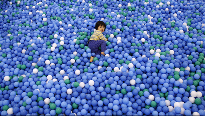 Child playing in ball pit