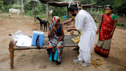 Healthcare worker Jankhana Prajapati gives a dose of the COVISHIELD vaccine against the coronavirus disease (COVID-19), manufactured by Serum Institute of India, to villager Amiyaben Dabhi during a door-to-door vaccination drive in Banaskantha district in the western state of Gujarat, India.