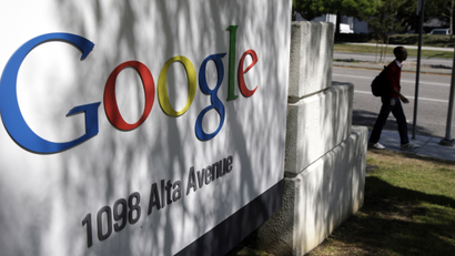 In this June 5, 2014 file photo, a man walks past a Google sign at the company's headquarters in Mountain View, Calif., U.S.A. The politically-fraught issue of forcing big, multinational companies to pay more tax will be high on the agenda at G-20 summit on Nov. 15 and 16 in Brisbane, Australia. There has been an ongoing effort by governments to crack down on tax avoidance, with companies such as Google and Amazon facing criticism for moving profits earned in one country to other countries with lower tax rates. (AP Photo/Marcio Jose Sanchez, File)