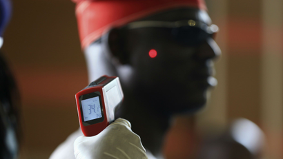 A man has his temperature taken using an infrared digital laser thermometer at the Nnamdi Azikiwe International Airport in Abuja, Nigeria.