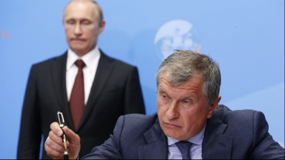 Rosneft CEO Igor Sechin finishes signing a document in St. Petersburg in May 2014.