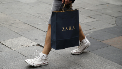 A man walks with a Zara bag in Madrid, Spain, June 10, 2015.