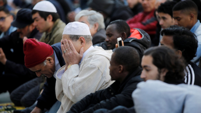 Muslims pray during Friday prayers in the street in Paris