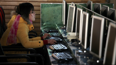 A woman uses a computer in an internet cafe at the centre of Shanghai, China January 13, 2010.