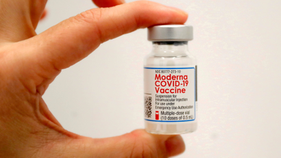 A healthcare worker holds a vial of the Moderna COVID-19 Vaccine at a vaccination site in New York