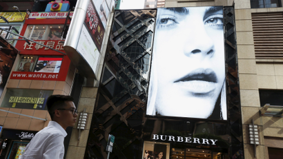 A model is seen on the screen of a Burberry store at Causeway Bay shopping district in Hong Kong, China, July 16, 2015.