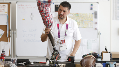 A technician works on a prosthetic leg for Britain's discus thrower Darren Derenalagi in Ottobock's workshop at the London Paralympic Games in 2012
