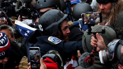 Pro-Trump protesters clash with police and pull out their phones to create videos and take photos during a riot to contest the certification of the 2020 U.S. presidential election results at the U.S. Capitol Building in Washington, U.S, January 6, 2021.