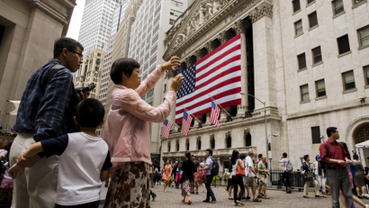 Chinese tourist visiting Wall Street in New York City.