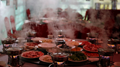 Hot steam rises from hotpots at Shangri-La Hotel's "Ice Palace" restaurant and bar in Harbin