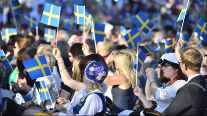 swedish flags being waved