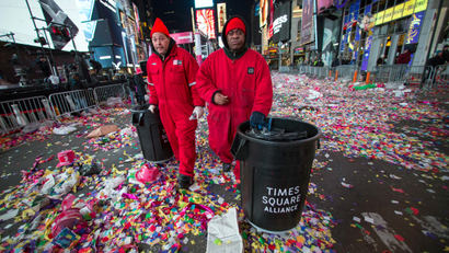 Workers prepare to clear confetti from the streets after New Year's Eve celebrations in Times Square, New York, January 1, 2015.