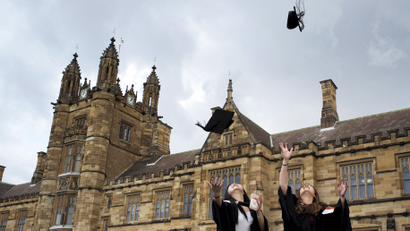 University students toss their graduation hats into the air for friends and family to take photos following their graduation ceremony at University of Sydney in Sydney, Australia, April 22, 2016.