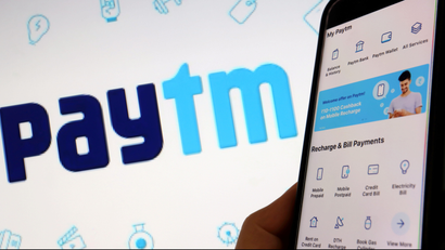 An image of the interface of Indian payments app Paytm is seen in front of its logo