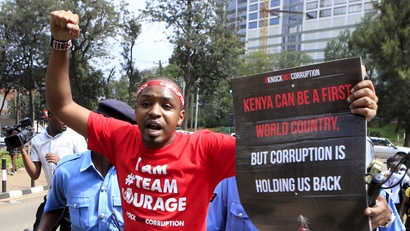Kenyan activist Boniface Mwangi is detained by police during a street protest on corruption in Kenya's capital Nairobi December 1, 2015.