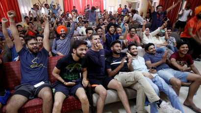 Indian cricket fans cheer as they watch on screen the Champions Trophy finals between India and Pakistan at London's The Oval, in a university hostel in Chandigarh