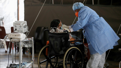 A healthcare worker tends to a patient at a temporary ward set up for Covid-19 at the Steve Biko Academic Hospital in Pretoria.