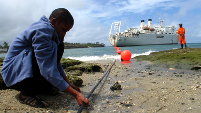 A Kenyan boy looks at the East African Marine Cable (TEAMS) fiber optic cable from the ship Niwa outside the Portuguese built Fort Jesus in the Kenyan coastal city of Mombasa, June 12, 2009. The cable has taken 18 months to reach the Kenyan coast by sea from the Middle East and is set to improve information and communication technology in Africa.